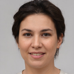 Joyful white young-adult female with medium  brown hair and brown eyes