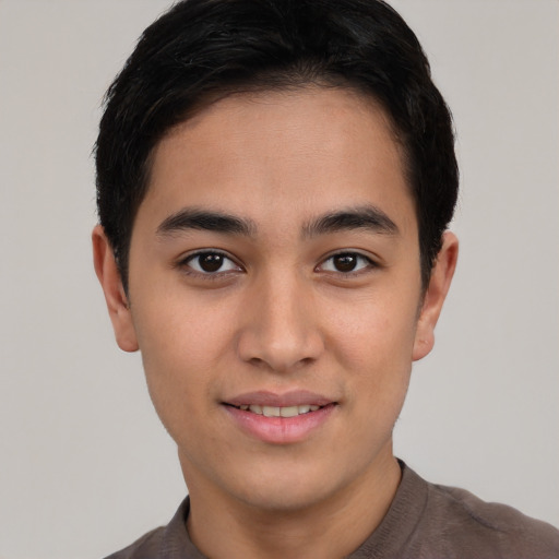 Joyful asian young-adult male with short  brown hair and brown eyes