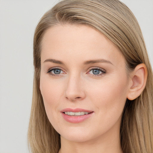 Joyful white young-adult female with long  brown hair and blue eyes