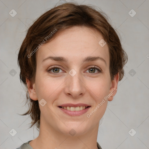 Joyful white young-adult female with medium  brown hair and green eyes