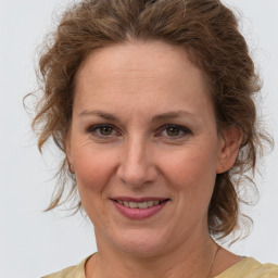 Joyful white adult female with medium  brown hair and brown eyes