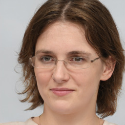 Joyful white adult female with medium  brown hair and blue eyes