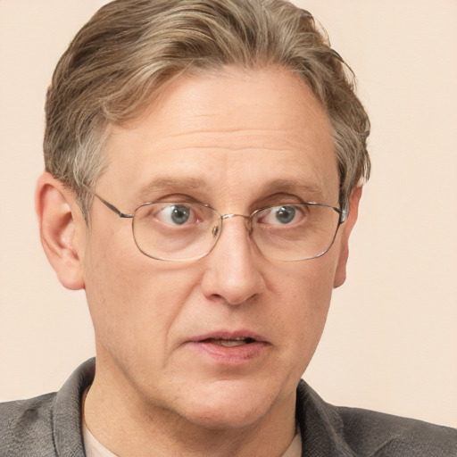 Joyful white middle-aged male with short  brown hair and blue eyes