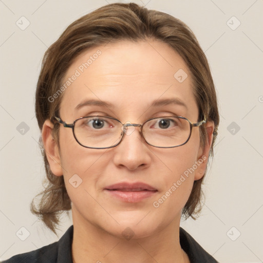 Joyful white adult female with medium  brown hair and grey eyes