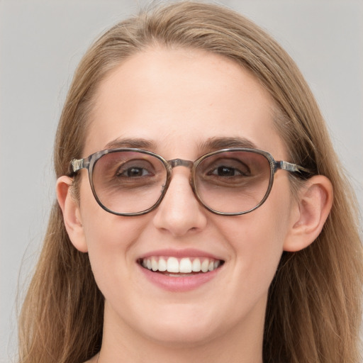 Joyful white adult female with long  brown hair and blue eyes