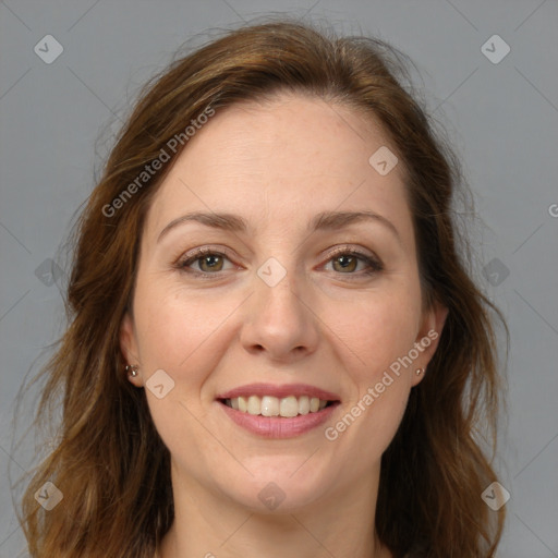 Joyful white adult female with long  brown hair and grey eyes