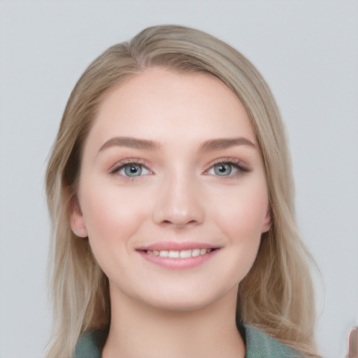 Joyful white young-adult female with long  brown hair and blue eyes