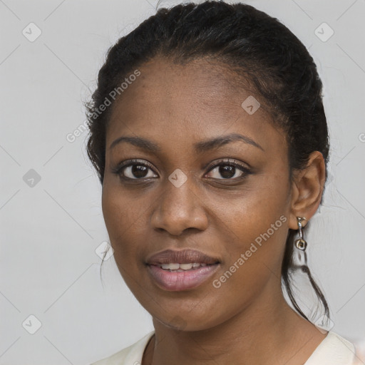 Joyful black young-adult female with long  brown hair and brown eyes