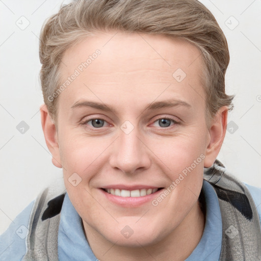 Joyful white young-adult female with short  brown hair and blue eyes