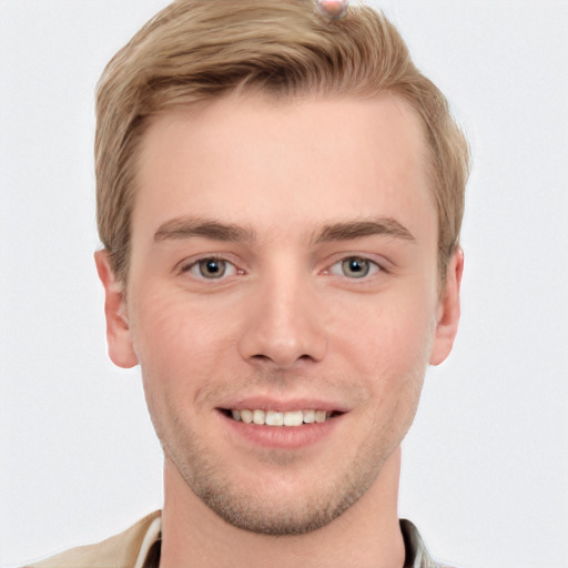 Joyful white young-adult male with short  brown hair and grey eyes