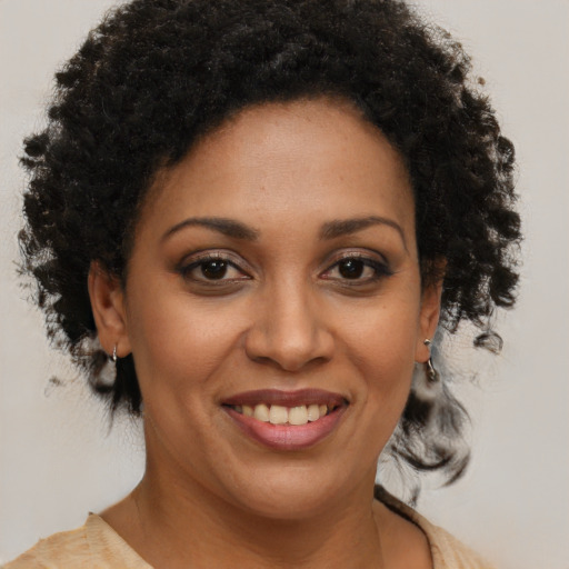 Joyful black young-adult female with short  brown hair and brown eyes