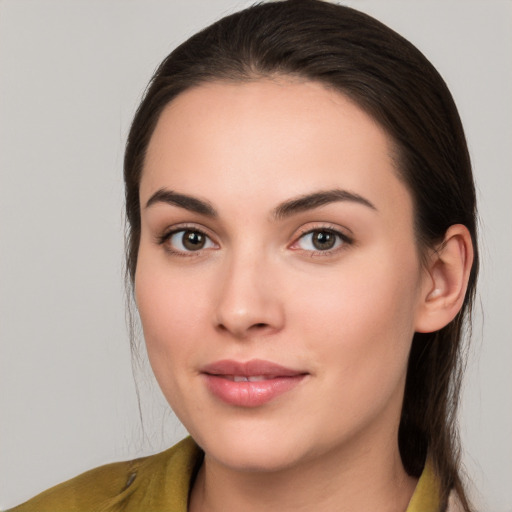 Joyful white young-adult female with long  brown hair and brown eyes