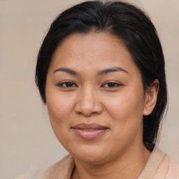 Joyful asian adult female with medium  brown hair and brown eyes