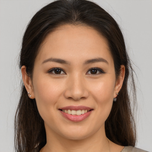 Joyful white young-adult female with long  brown hair and brown eyes