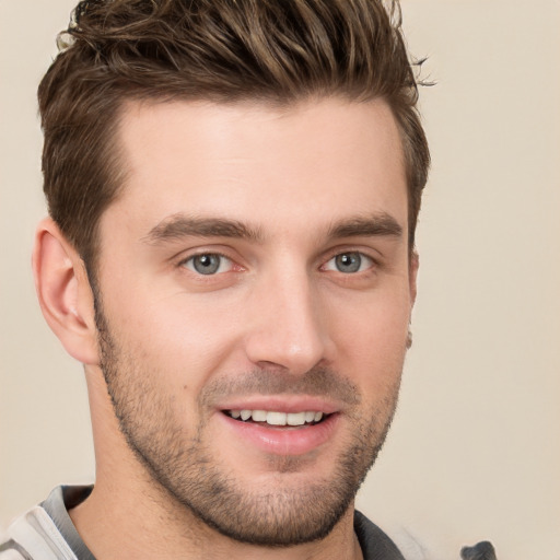 Joyful white young-adult male with short  brown hair and grey eyes