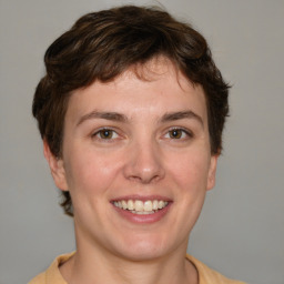 Joyful white young-adult female with short  brown hair and grey eyes