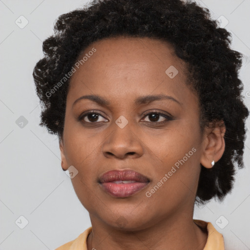 Joyful black adult female with short  brown hair and brown eyes