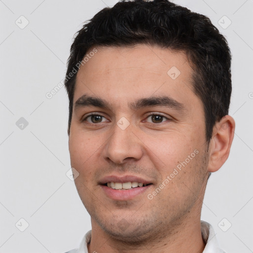 Joyful white young-adult male with short  black hair and brown eyes