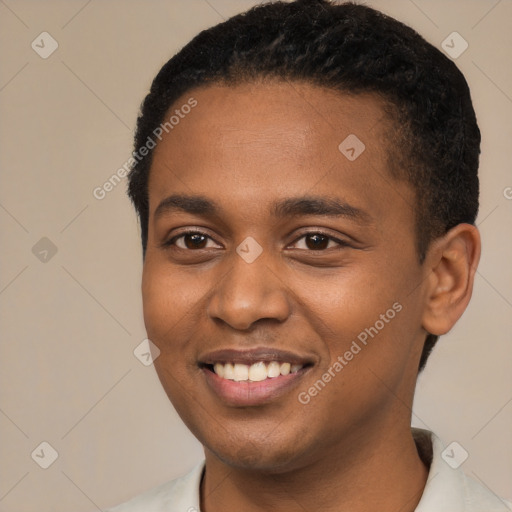 Joyful black young-adult male with short  black hair and brown eyes