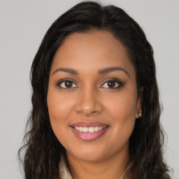 Joyful latino young-adult female with long  brown hair and brown eyes