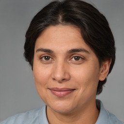 Joyful white adult female with medium  brown hair and brown eyes