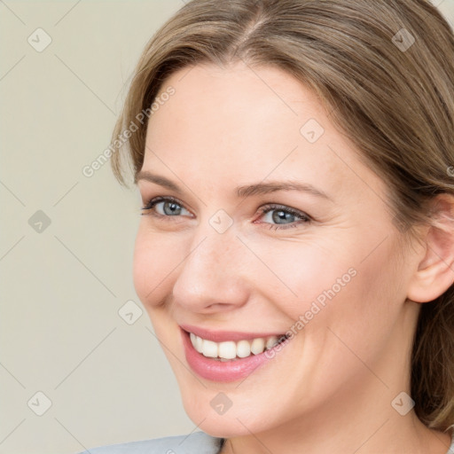 Joyful white young-adult female with medium  brown hair and blue eyes