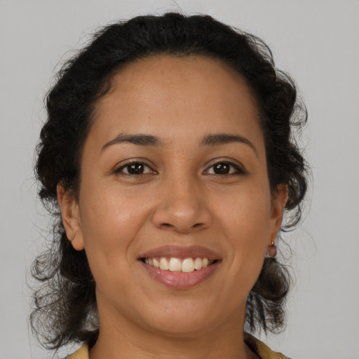 Joyful latino young-adult female with medium  brown hair and brown eyes