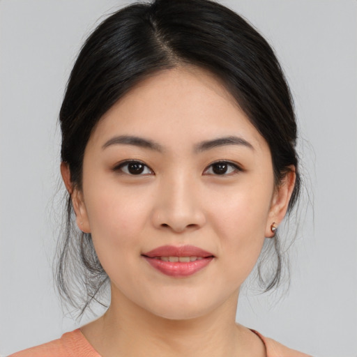 Joyful asian young-adult female with medium  brown hair and brown eyes