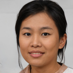 Joyful asian young-adult female with medium  brown hair and brown eyes