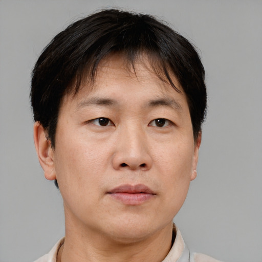 Neutral asian adult male with short  brown hair and brown eyes