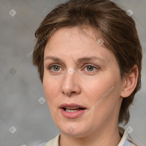 Joyful white adult female with medium  brown hair and grey eyes