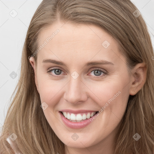 Joyful white young-adult female with long  brown hair and grey eyes