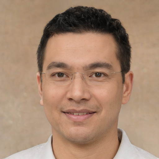 Joyful white young-adult male with short  black hair and brown eyes