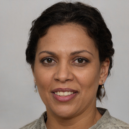 Joyful white adult female with short  brown hair and brown eyes