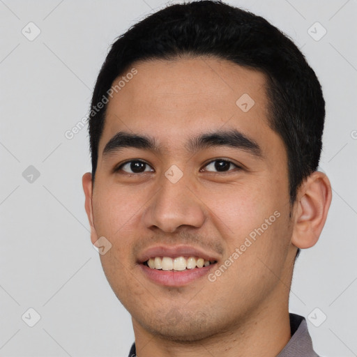 Joyful latino young-adult male with short  black hair and brown eyes