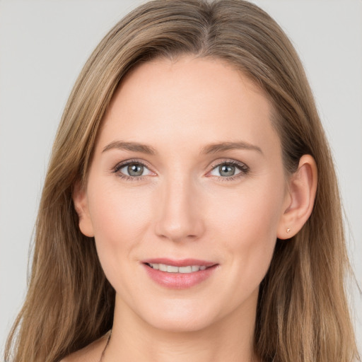 Joyful white young-adult female with long  brown hair and grey eyes