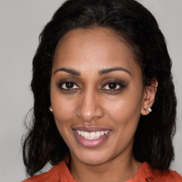 Joyful black young-adult female with medium  brown hair and brown eyes