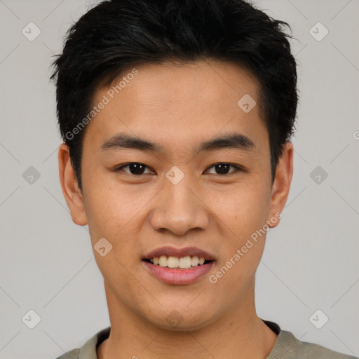 Joyful asian young-adult male with short  black hair and brown eyes