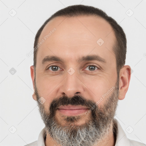 Joyful white adult male with short  black hair and brown eyes