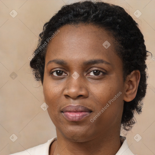 Joyful black young-adult female with short  black hair and brown eyes