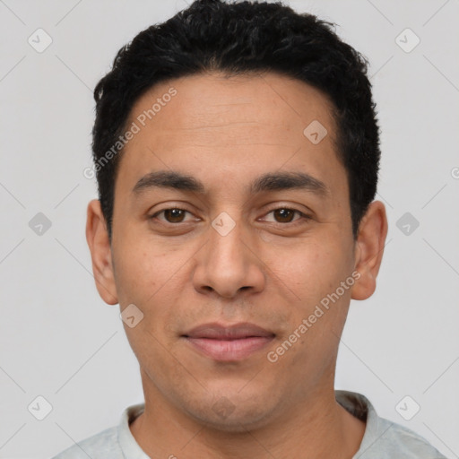 Joyful latino young-adult male with short  black hair and brown eyes