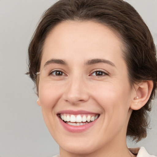 Joyful white young-adult female with medium  brown hair and brown eyes