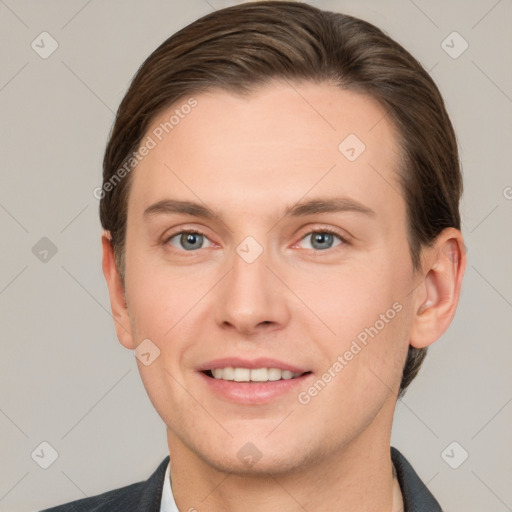 Joyful white young-adult male with short  brown hair and grey eyes