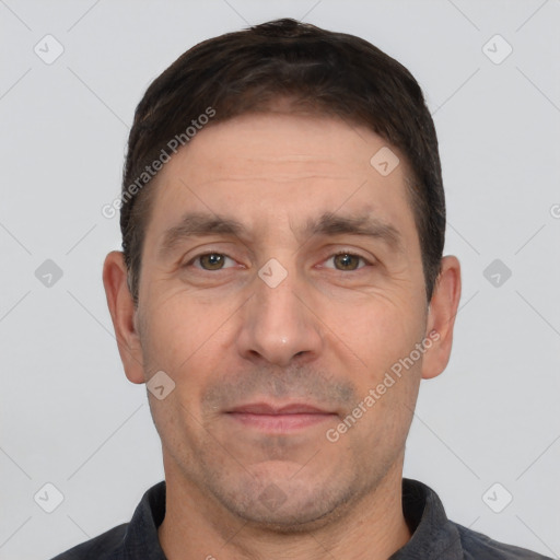 Joyful white adult male with short  brown hair and brown eyes