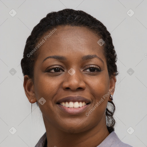 Joyful black young-adult female with short  black hair and brown eyes