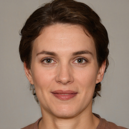 Joyful white adult female with medium  brown hair and grey eyes