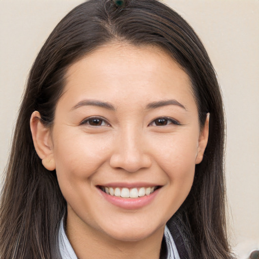 Joyful white young-adult female with long  brown hair and brown eyes