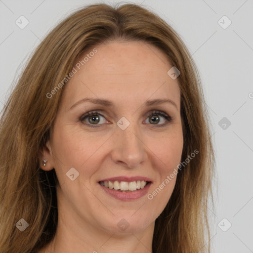 Joyful white adult female with long  brown hair and brown eyes