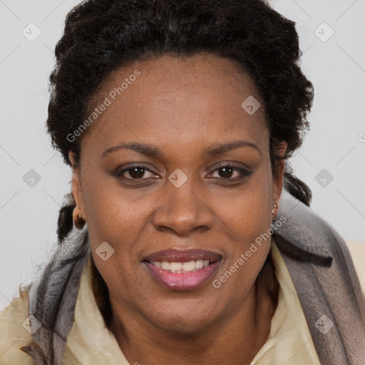 Joyful black adult female with short  brown hair and brown eyes