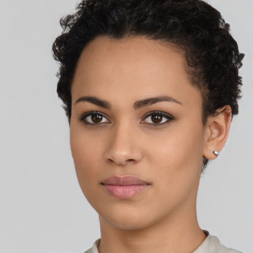 Joyful latino young-adult female with short  brown hair and brown eyes